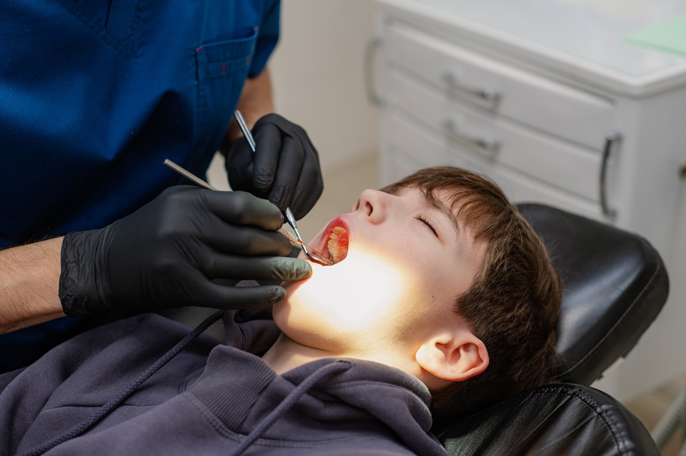A young boy receiving gentle pediatric dental care in a comfortable clinical setting – Dentist in Torrance CA.