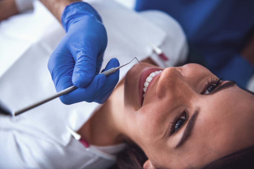 A close-up view of a dental examination using precision instruments to maintain healthy teeth and gums - Dentist in San Pedro CA