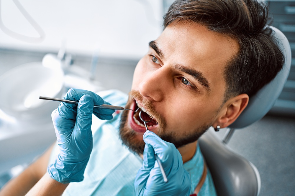 A dental professional performs a thorough oral examination using specialized tools to ensure optimal dental health - Dentist in San Pedro CA