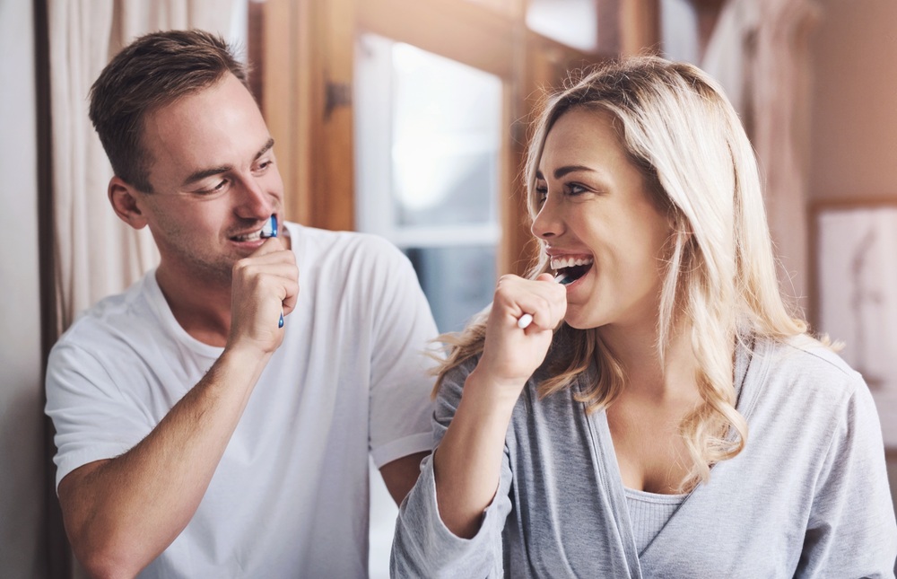 A couple practicing healthy oral hygiene habits at home, emphasizing the importance of daily brushing and preventive dental care – Dentist in Palos Verdes.