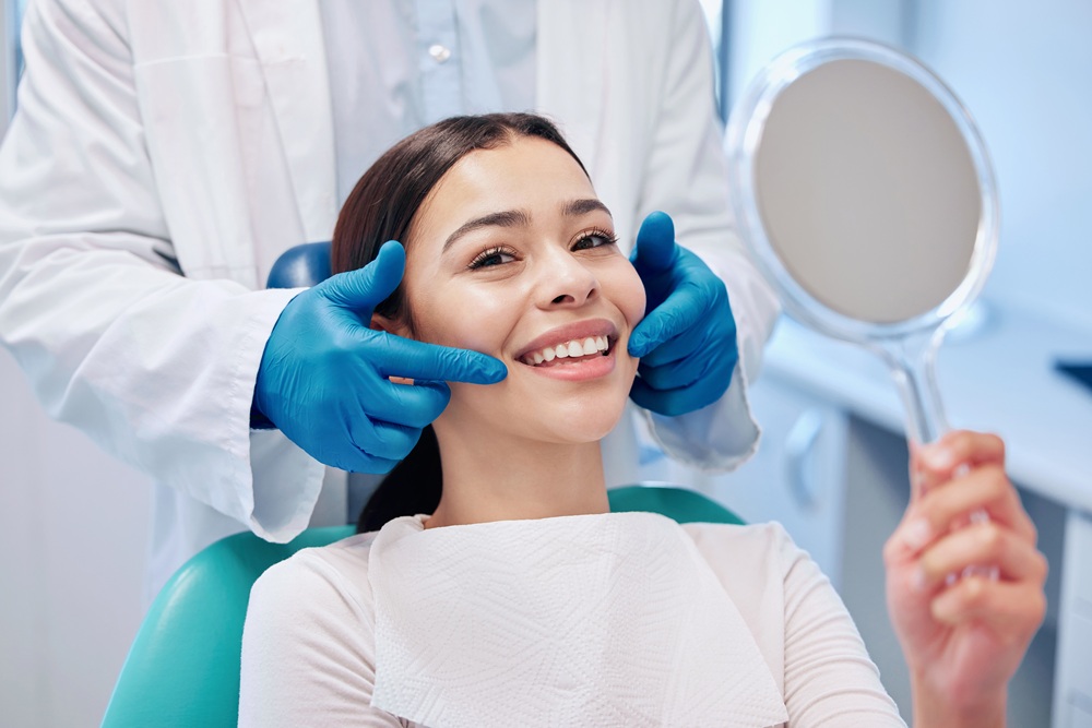 Dental Checkup and Smile Assessment by Hygienist – Preventative Dentistry in Redondo Beach A patient smiles while a dental professional evaluates her teeth, emphasizing routine exams and cleanings to maintain long-term oral health. – Preventative Dentistry in Redondo Beach