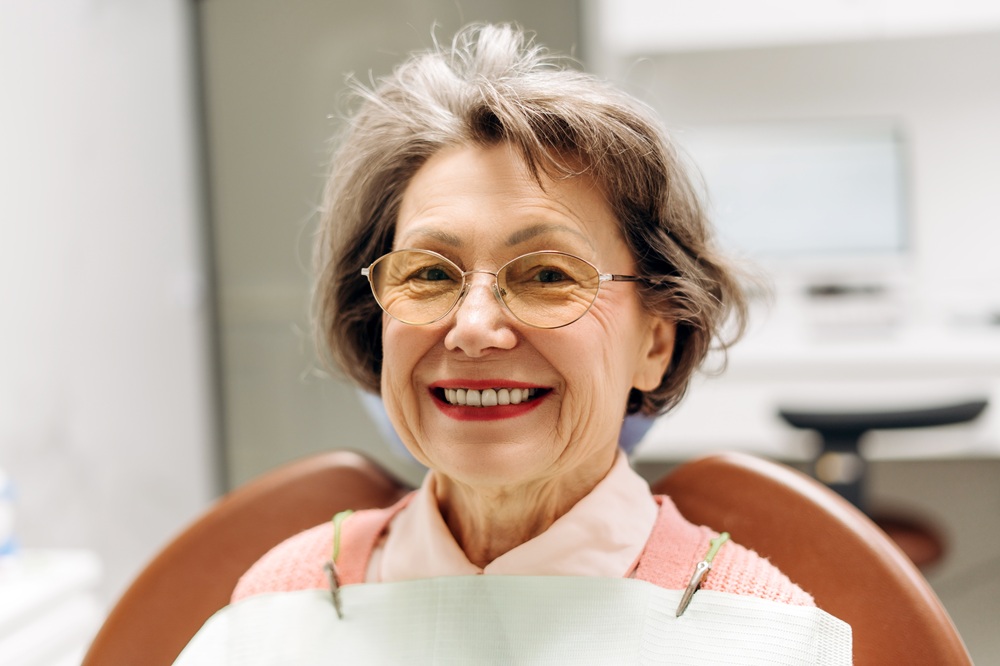 An older adult smiling confidently after receiving personalized and attentive dental care – Dentist in Palos Verdes.