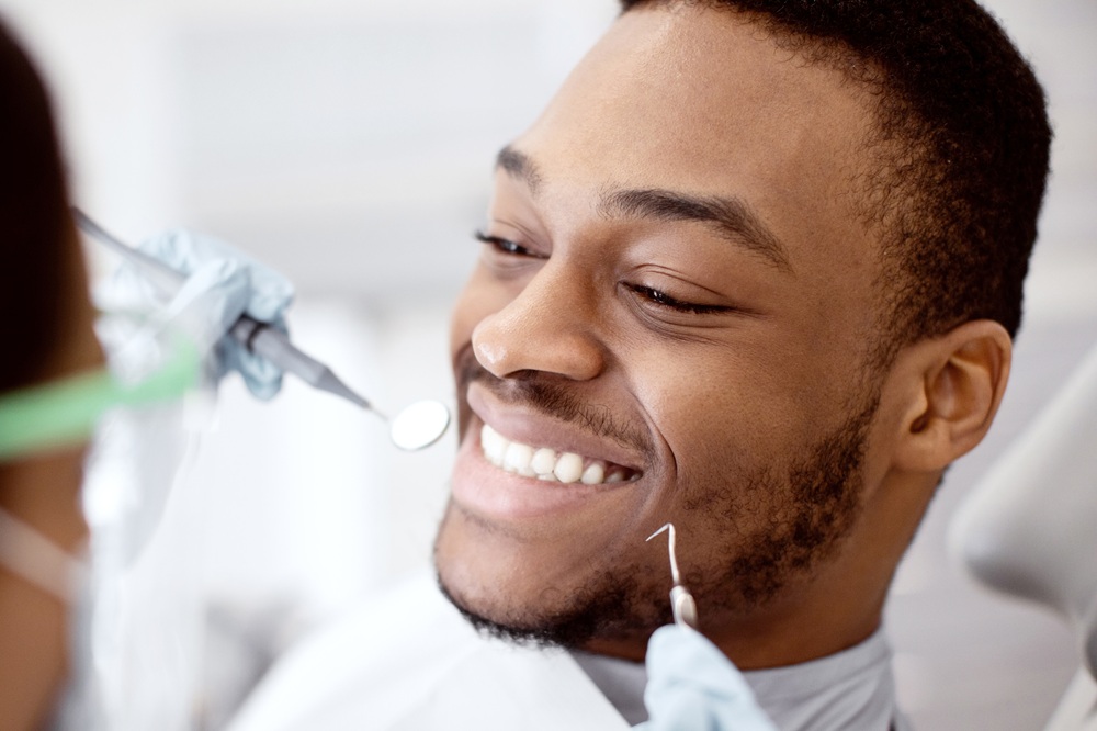 A patient relaxes comfortably while a dental professional performs a routine cleaning using specialized tools to remove plaque and maintain healthy gums. – Dental Cleaning in Torrance CA