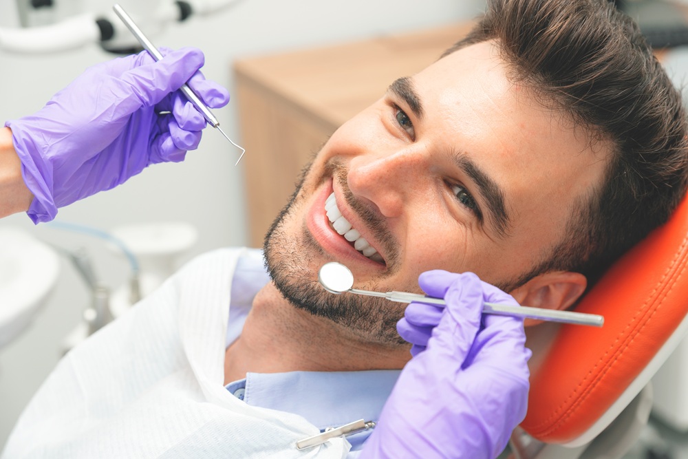 Professional Dental Cleaning in Modern Office – Preventative Dentistry in Redondo Beach A patient smiles during a routine cleaning appointment, helping remove plaque buildup and maintain strong, healthy teeth. – Preventative Dentistry in Redondo Beach