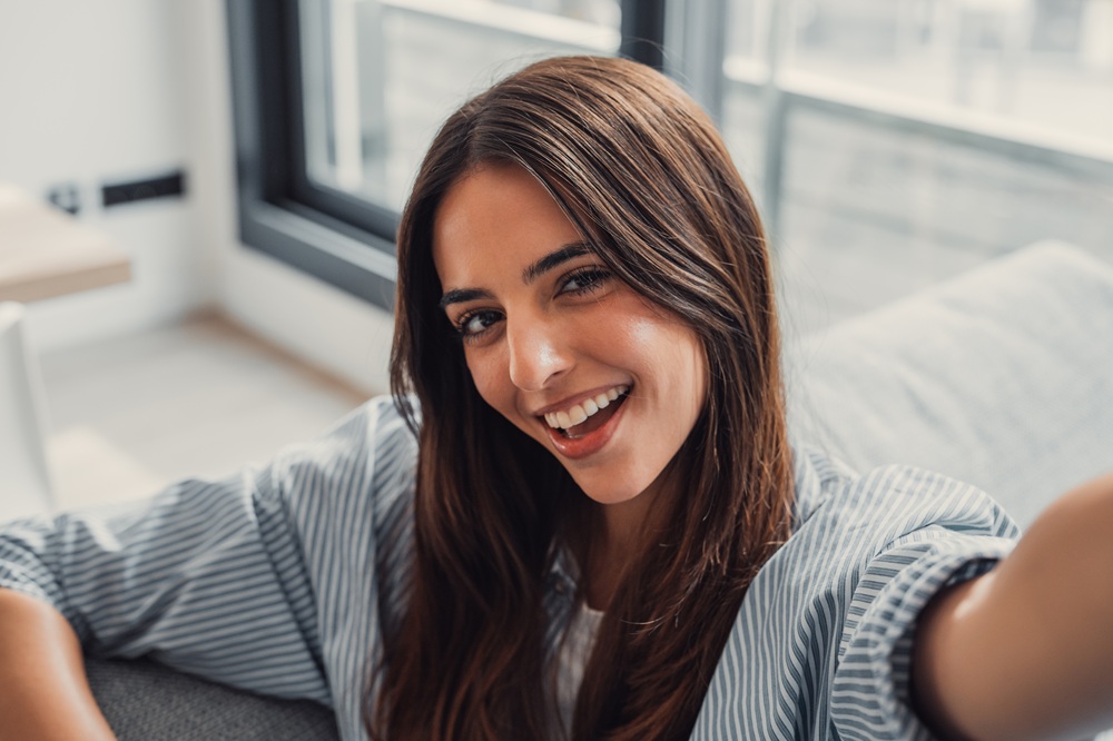 A close-up of a smiling woman at home, highlighting the confidence that comes from professional cleanings and cosmetic dentistry – Dentist in Torrance CA.