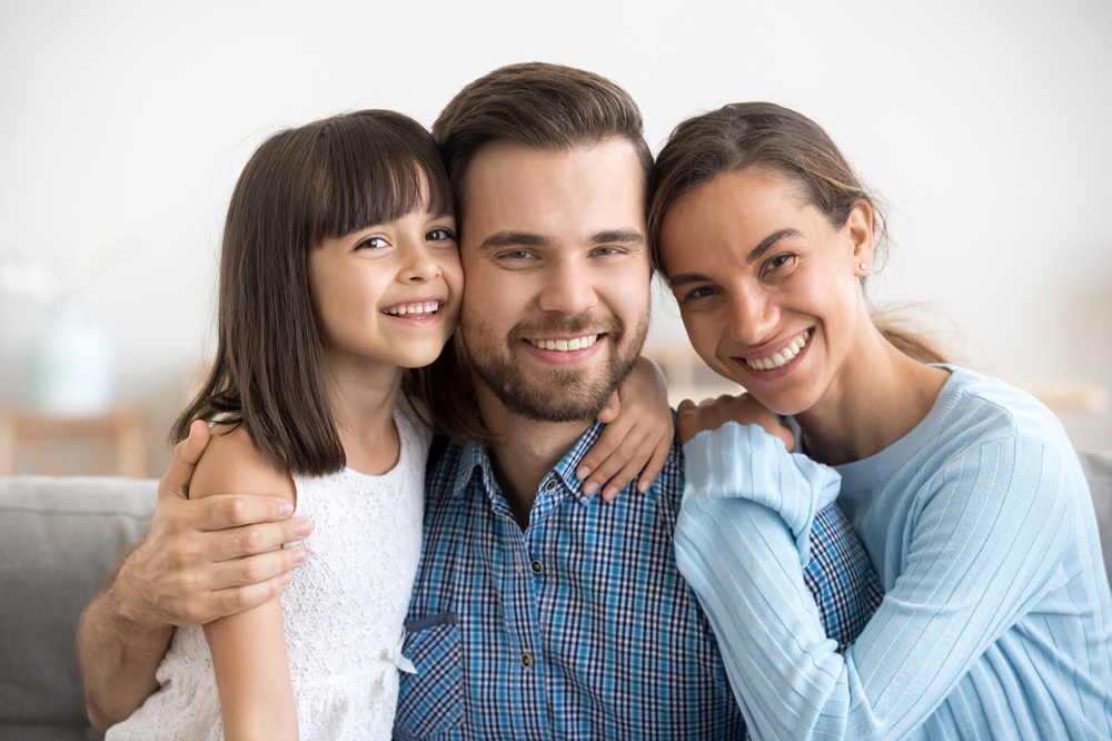A smiling family showing confident, healthy smiles that reflect the benefits of regular dental checkups and preventive care – Dentist in Palos Verdes.