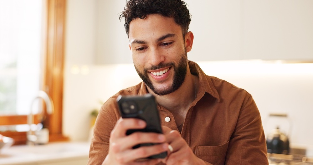 A man smiling confidently at home after maintaining his oral health with routine professional dental care and preventive cleanings – Redondo Beach Dental Cleanings