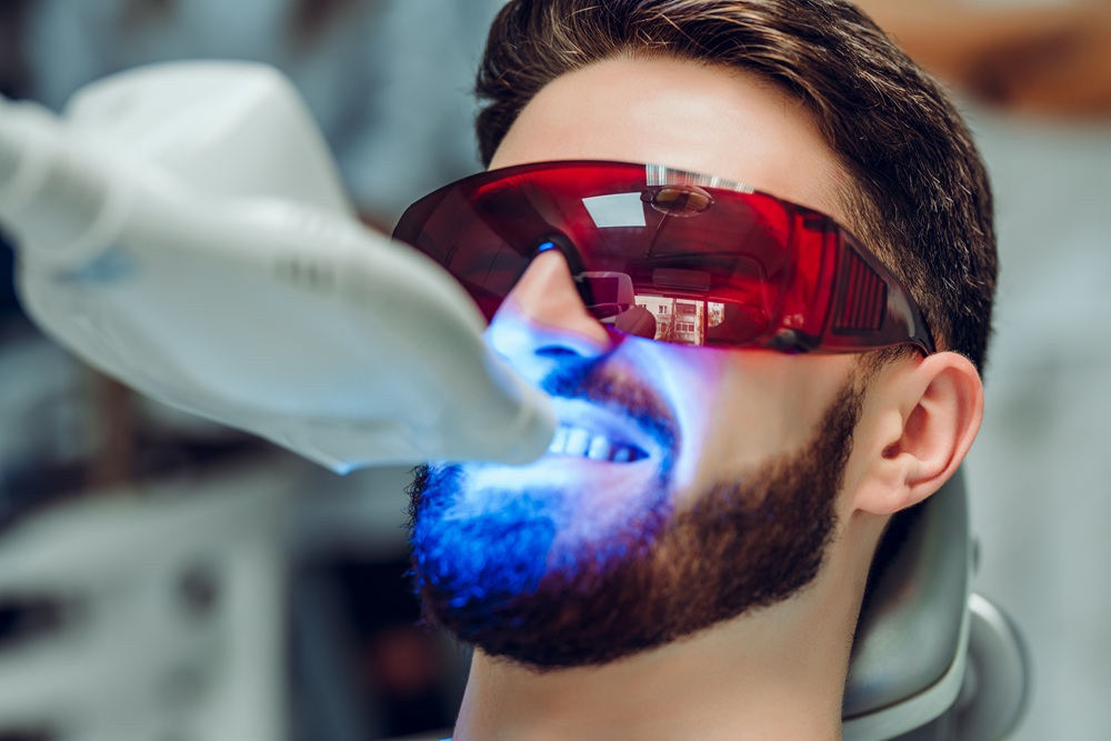 Laser Teeth Whitening Procedure with Protective Eyewear – Laser Dentistry in Torrance CA A patient undergoes professional laser teeth whitening while wearing protective glasses, enhancing smile brightness safely and effectively. – Laser Dentistry in Torrance CA