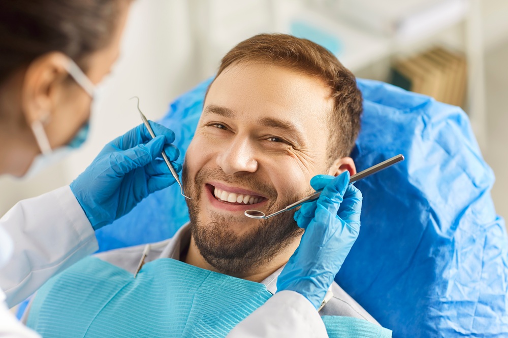 A smiling patient undergoing a professional dental checkup, demonstrating gentle and attentive preventive care – Dentist in Torrance CA.