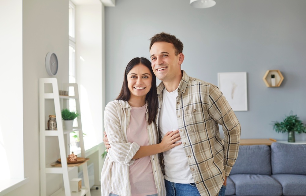 A couple standing together with bright smiles, representing the confidence that comes from quality dental care – Dentist in Palos Verdes.