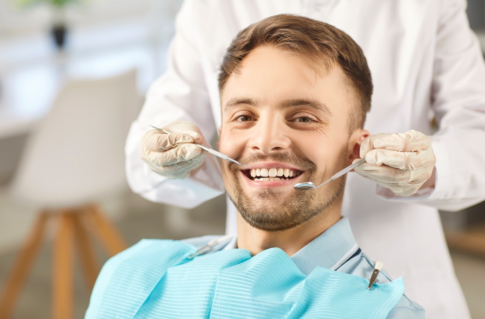 A satisfied patient smiles during a routine dental appointment, demonstrating comfort and quality care in a modern dental setting - Dentist in San Pedro CA
