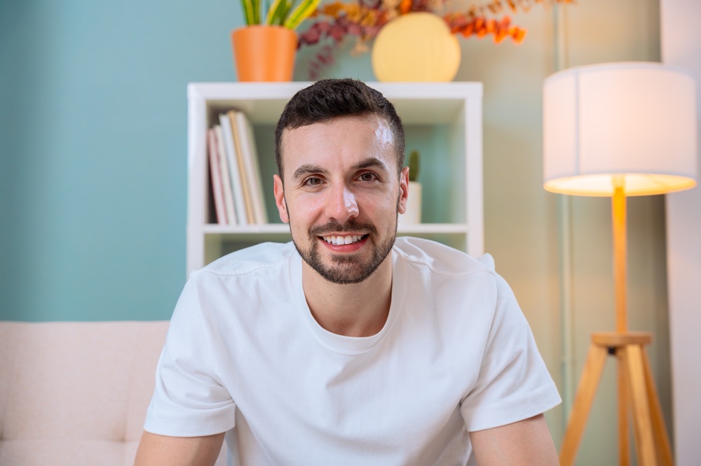 A young man smiling confidently, representing the results of quality dental care and modern treatment options – Dentist in Palos Verdes.