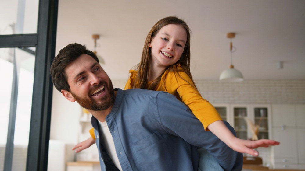 A happy father and daughter sharing a playful moment, reflecting family-centered dental care and healthy smiles – Dentist in Torrance CA.