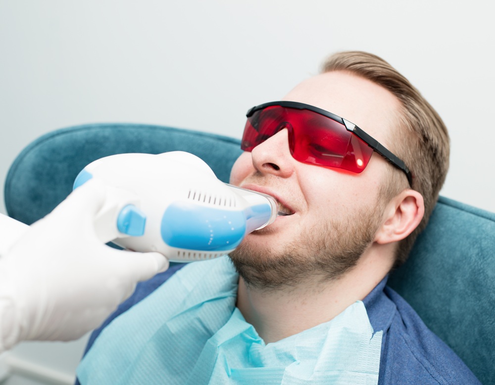A man receiving in-office teeth whitening treatment using modern dental technology – Dentist in Torrance CA.