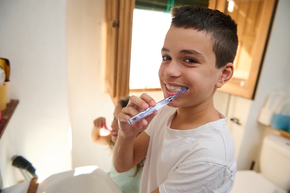 A young child brushing his teeth at the sink, promoting good oral hygiene habits and pediatric dental care – Dentist in Redondo Beach.